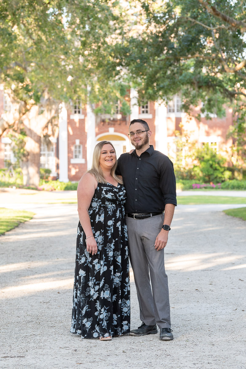 engaged couple stand along drive leading up to mansion at Bay Preserve at Osprey