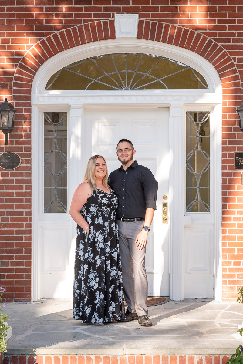 engagement photo of couple in front of door at Bay Preserve