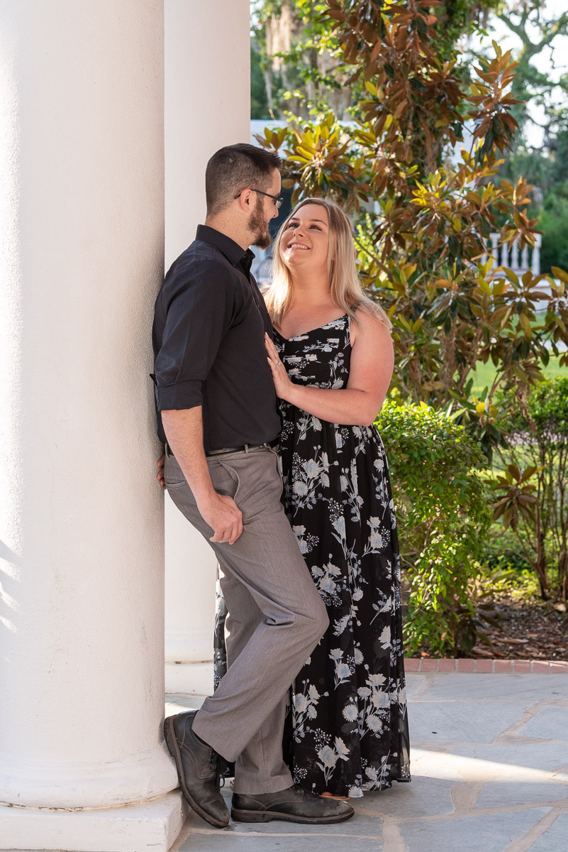 couple leaning against the pillar on the front porch