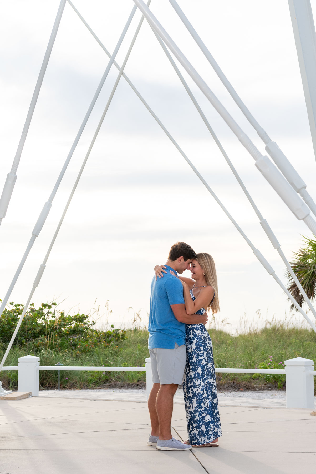 Will and Hannah take a moment to embrace by the lighthouse on Boca Grande