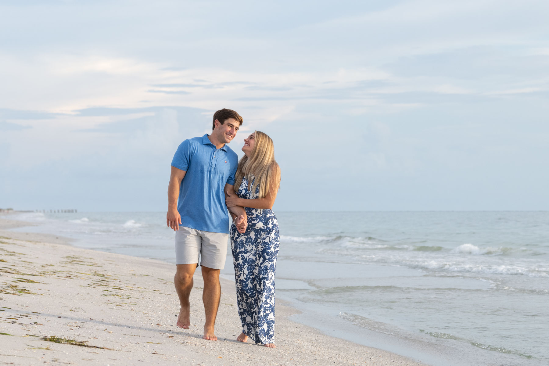 Will and Hannah walk along the Boca Grande Beach after their engagement