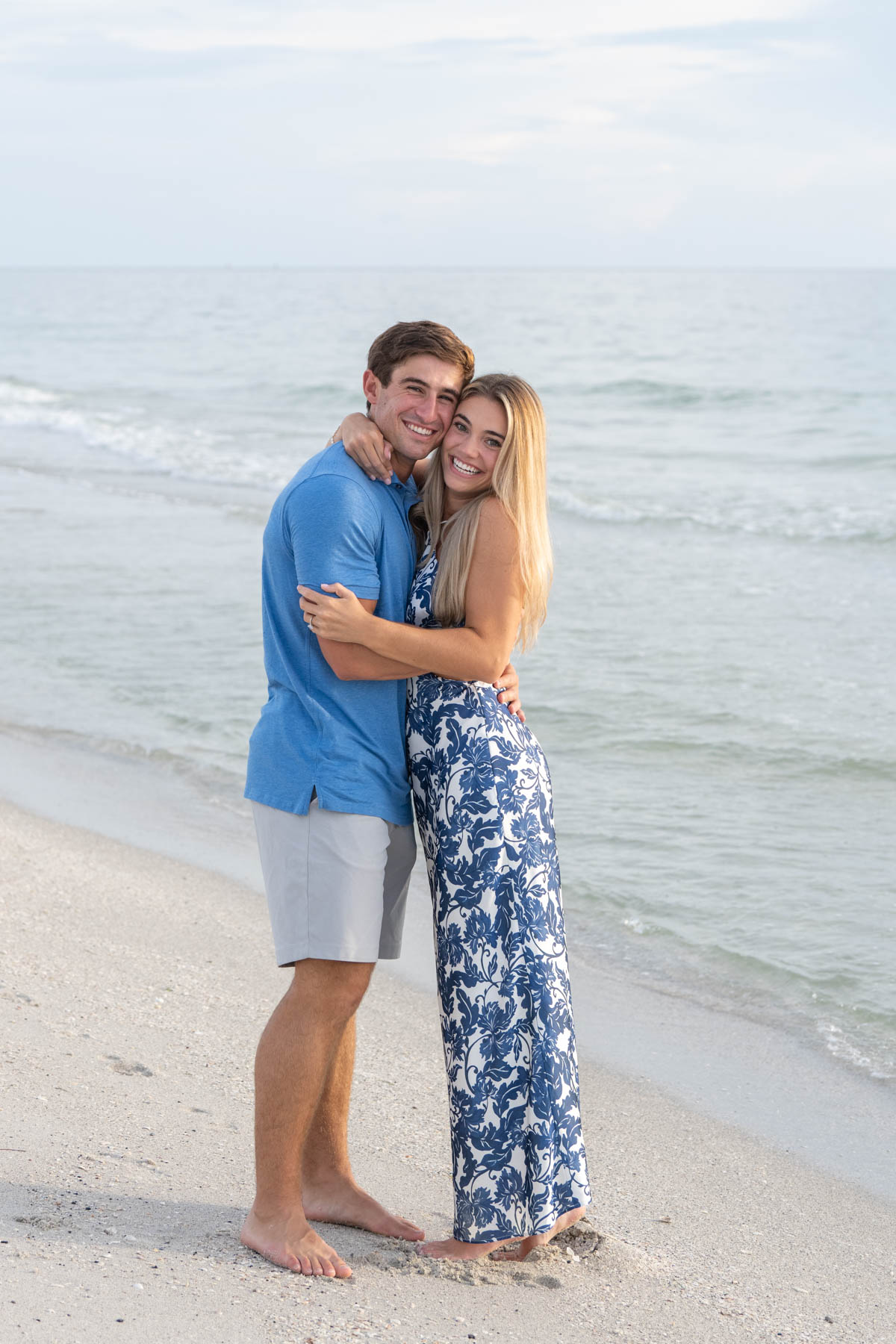 Will and Hannah hold each other close as they smile after their engagement on Boca Grande