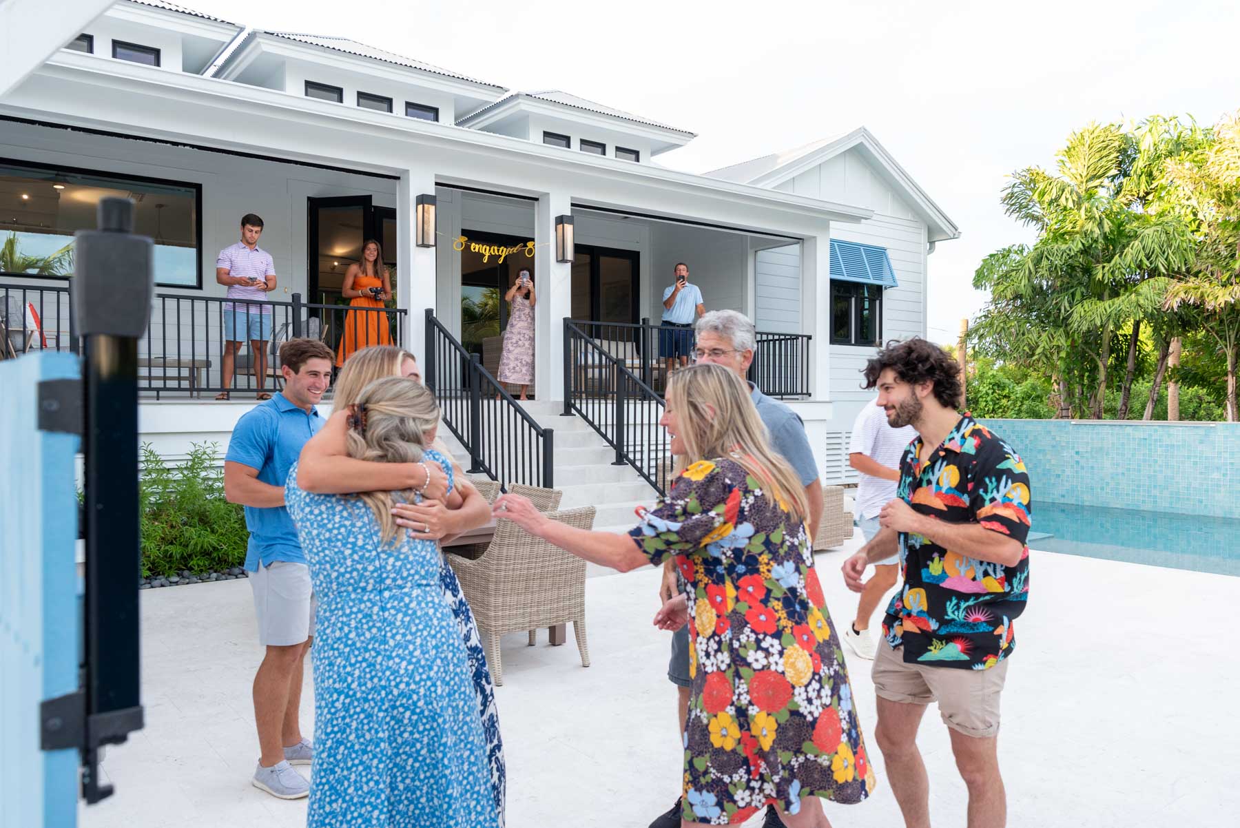 the family hugs the newly engaged couple