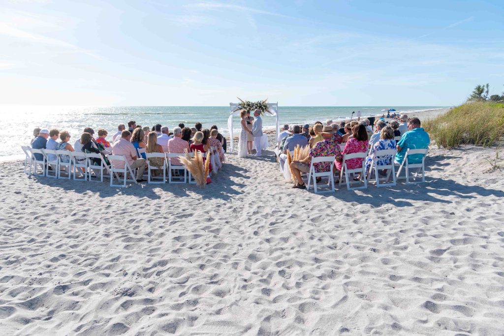 Englewood Beach wedding with bride and groom saying their vows as their guests look on