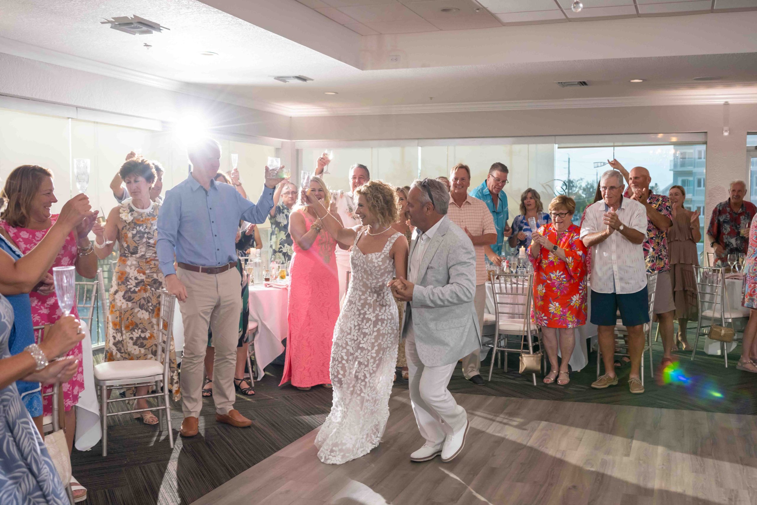 bride and groom dance while the guests look on
