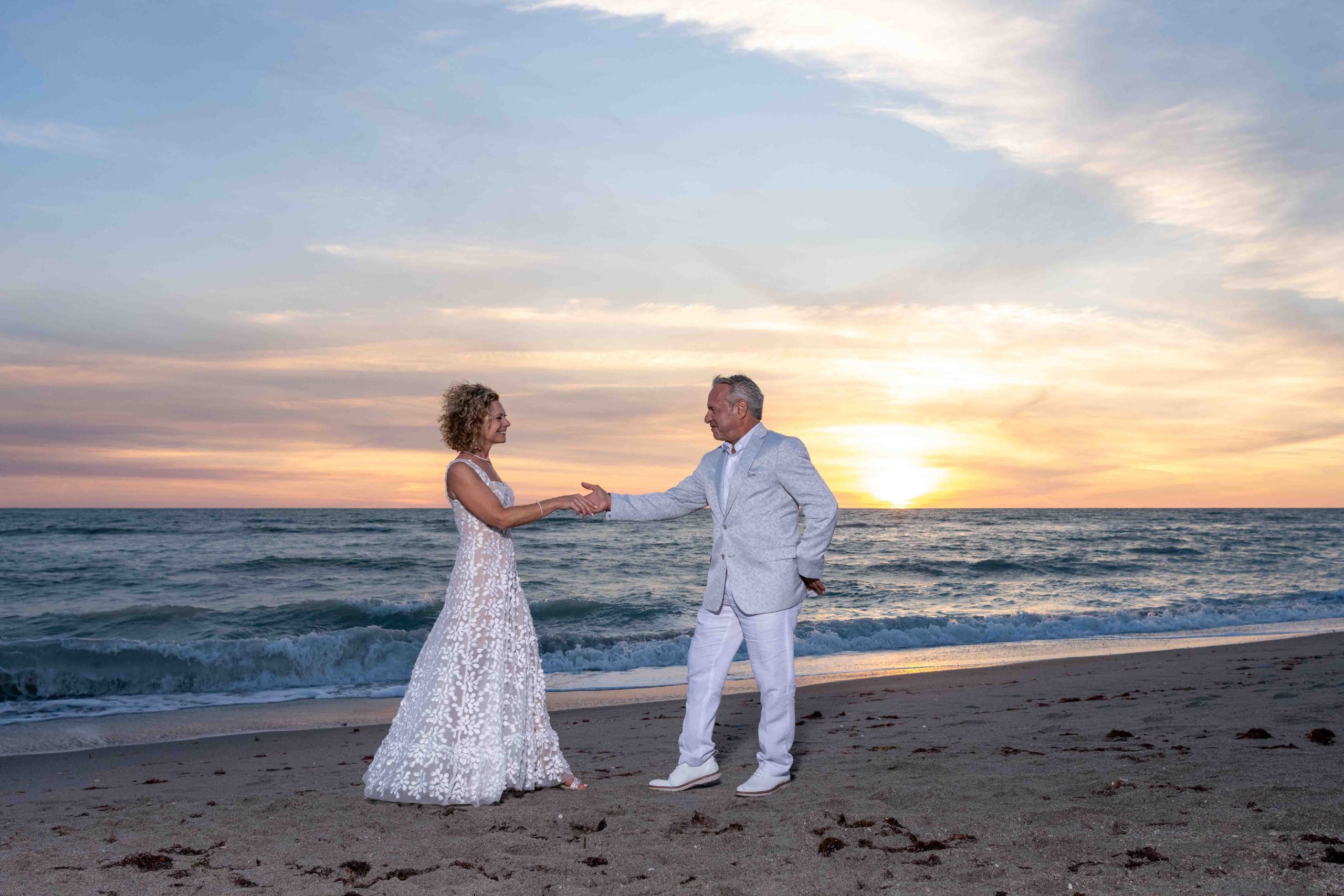 couple dance on the beach at sunset