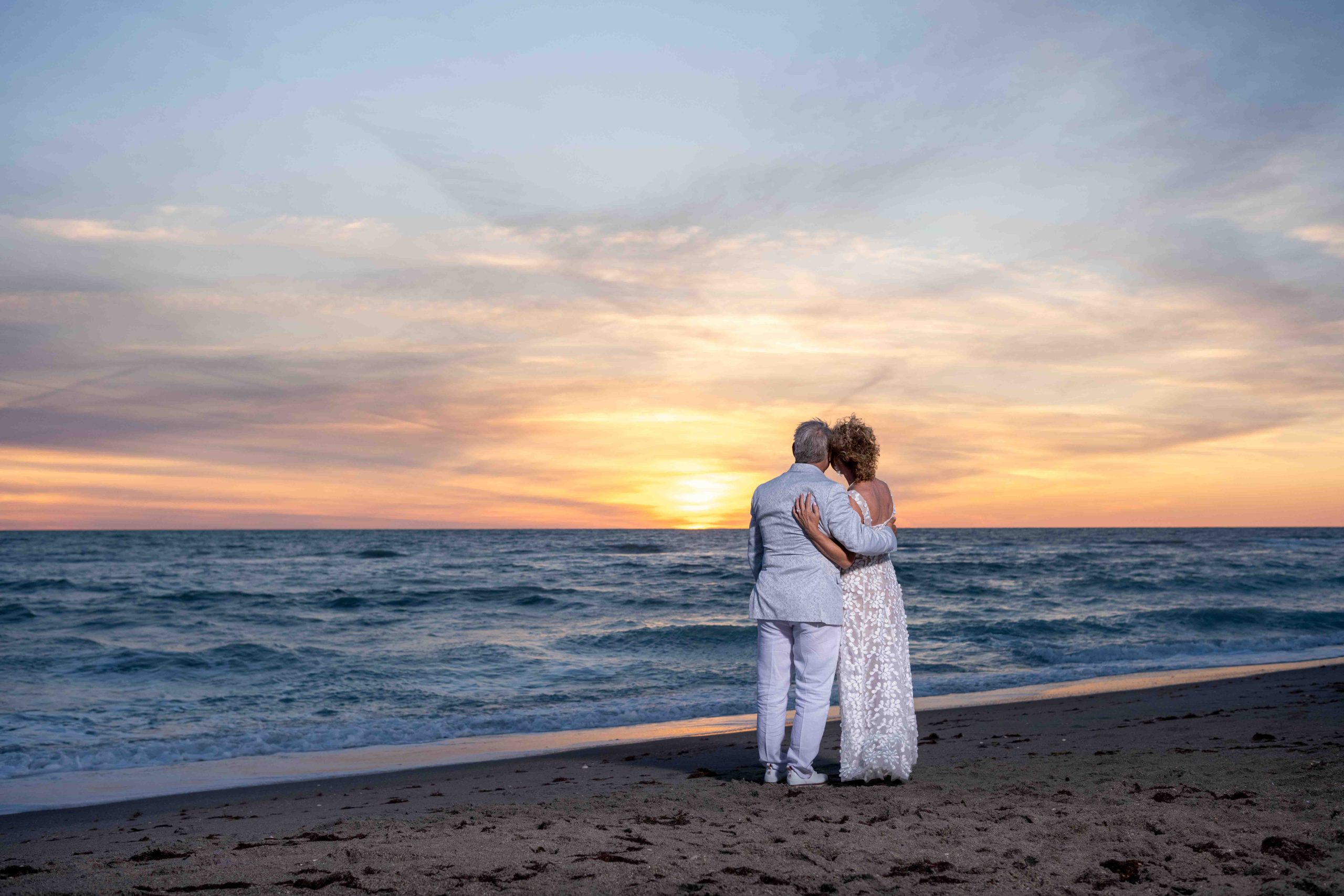 couple watch their first sunset as husband and wife on Englewood Beach