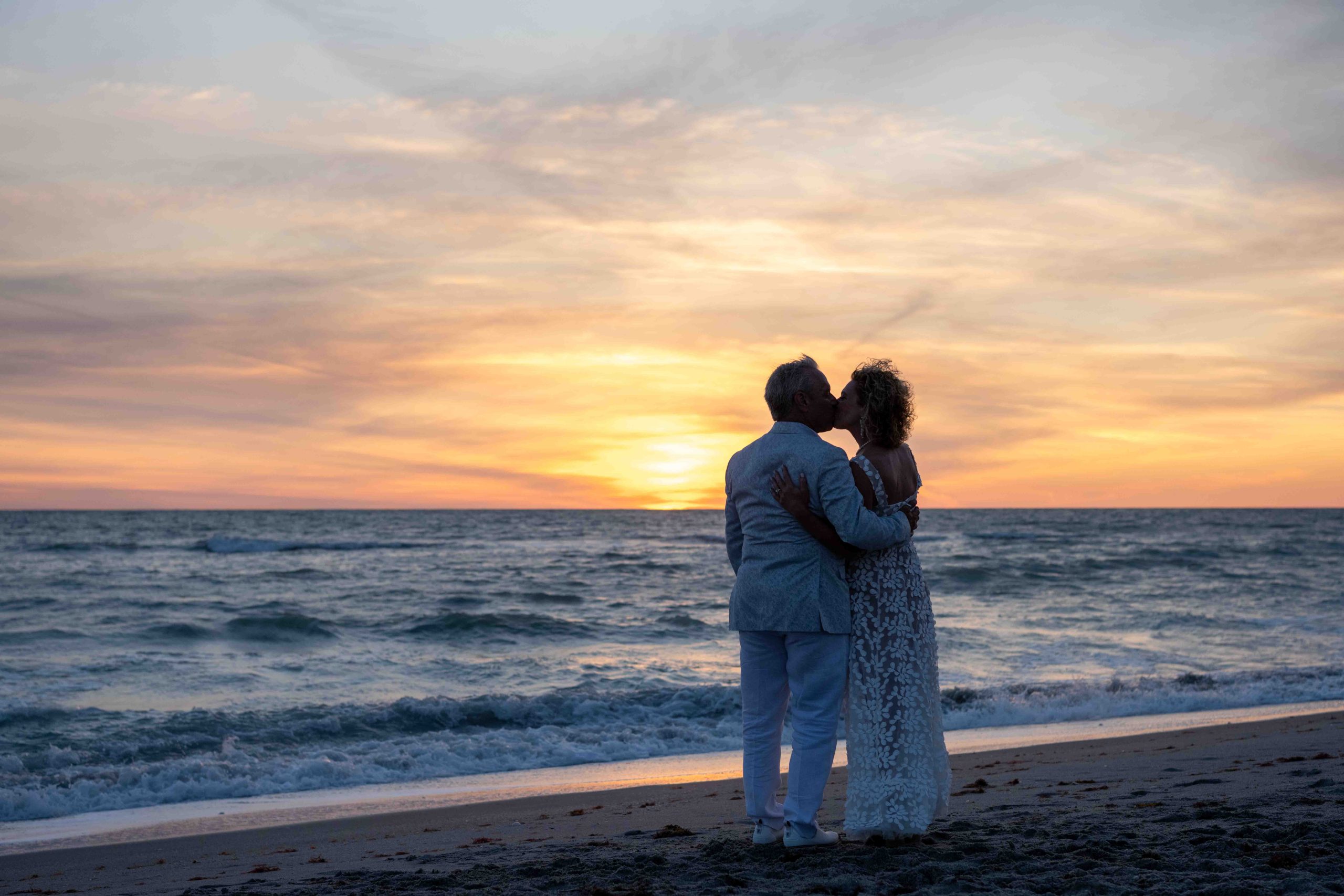 silhouette of bride and groom kissing