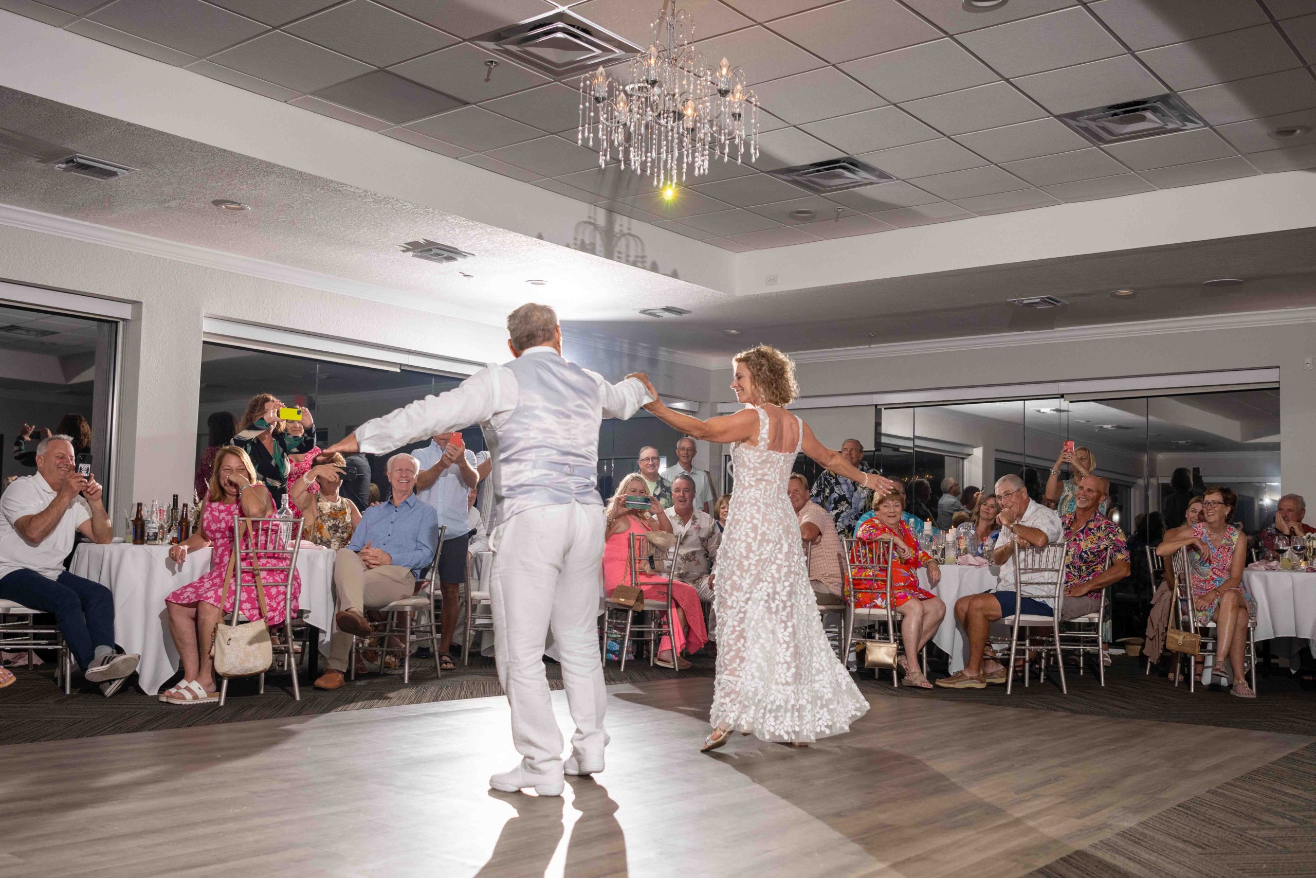 groom twirls his bride around the dance floor during wedding reception at The Waverly