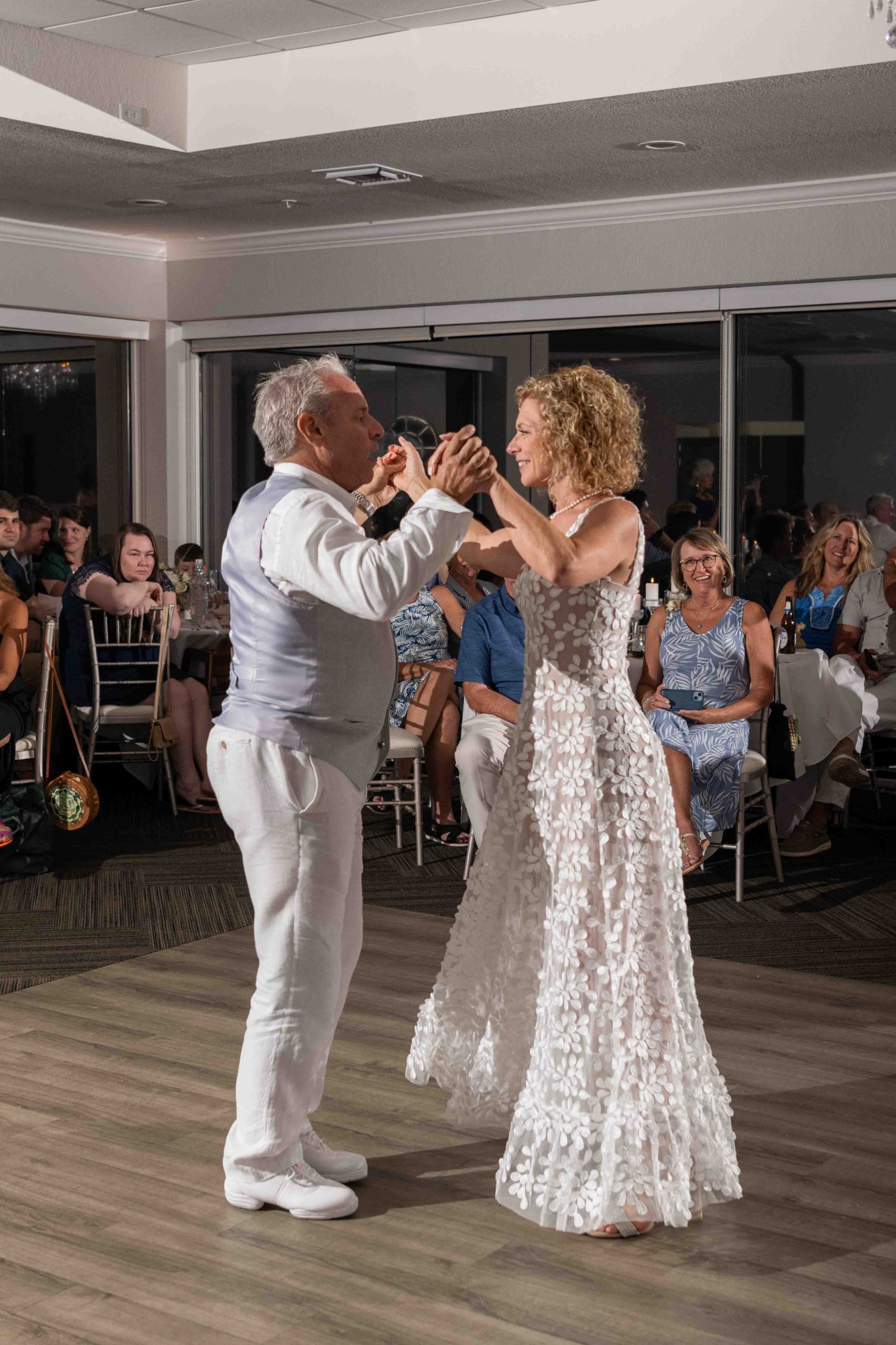 bride and groom look lovingly at each other while they dance
