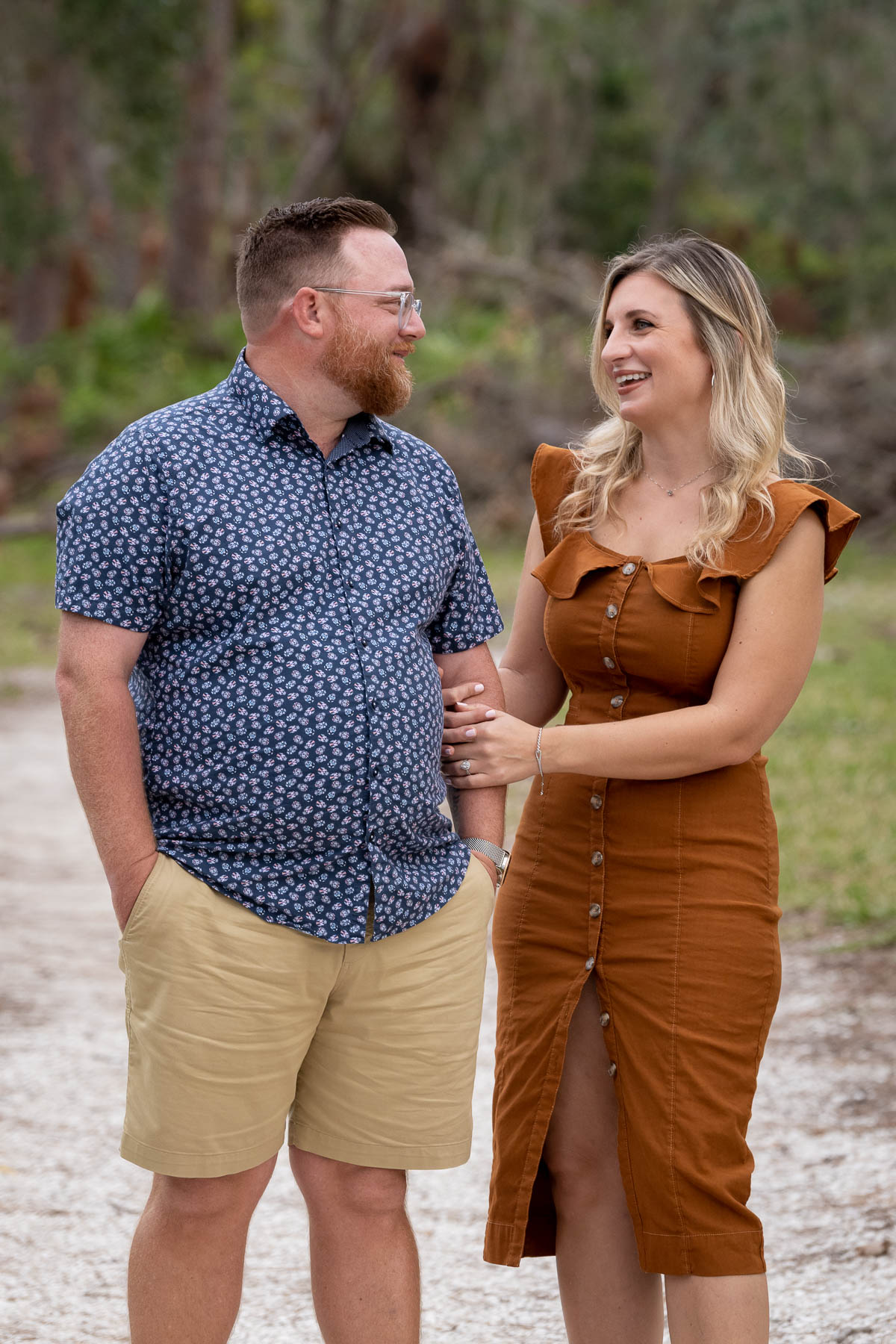 girl holding her fiance's arm and smiling at him