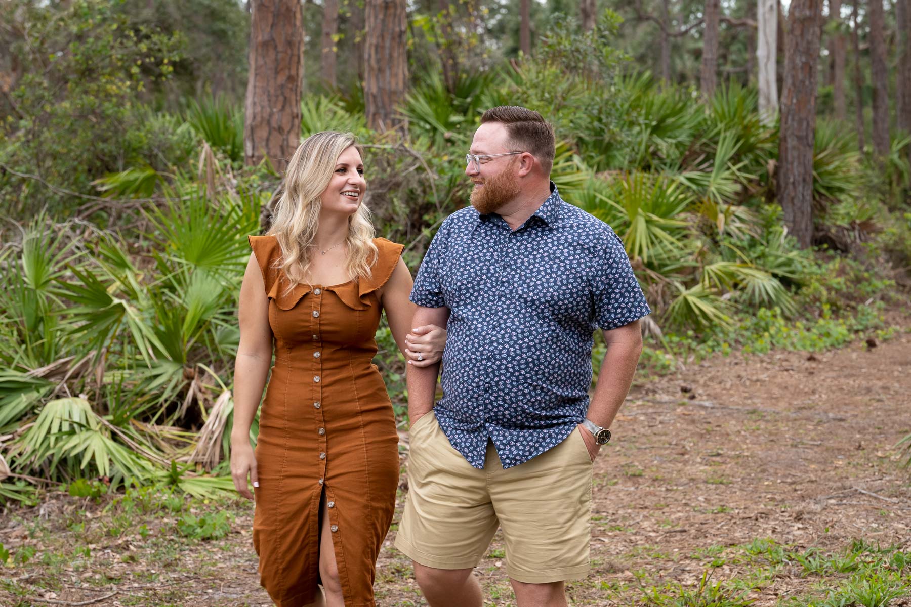 couple walk arm in arm through Lemon Bay Park