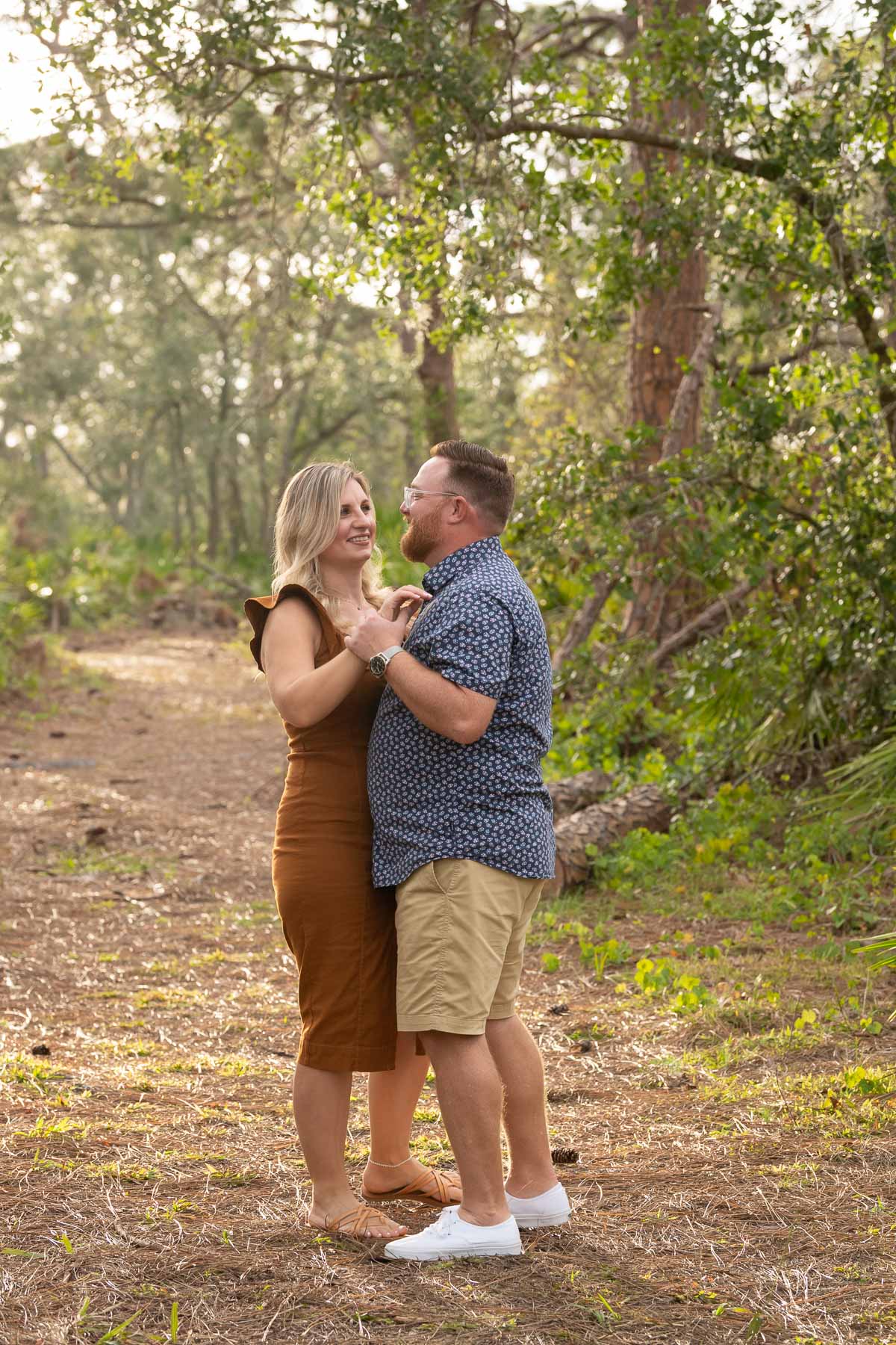 man and woman dancing in a park