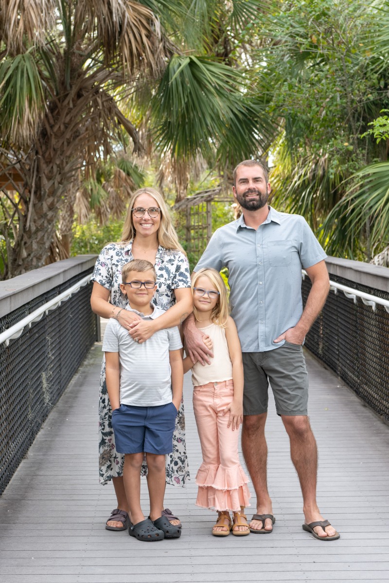 young parents with their son and daughter on a boardwalk