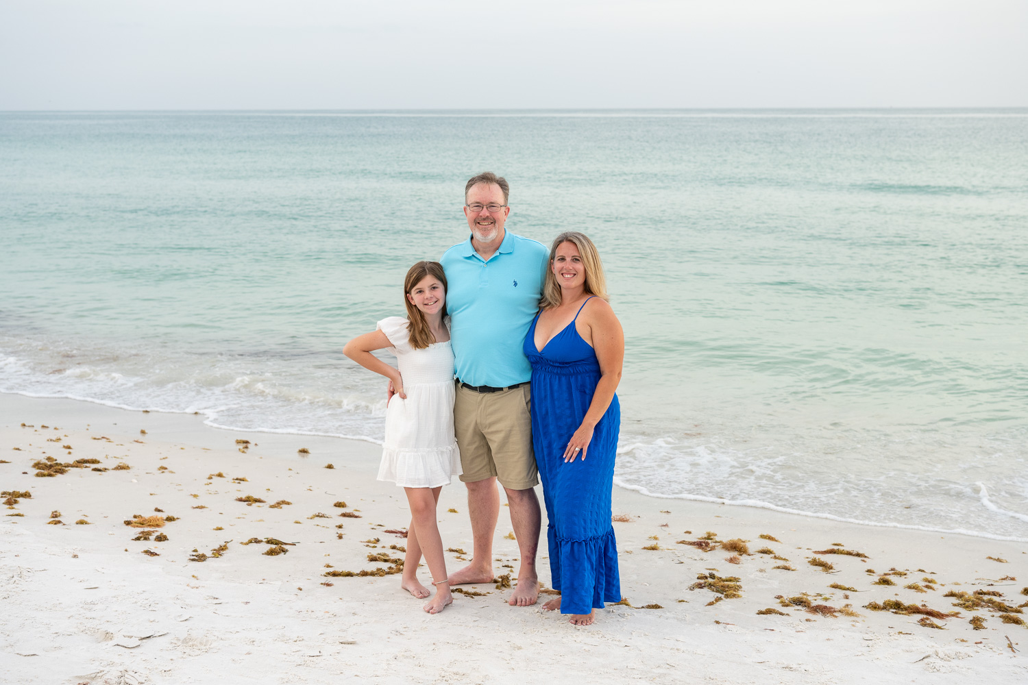 family with teen girl stand on Lido Beach