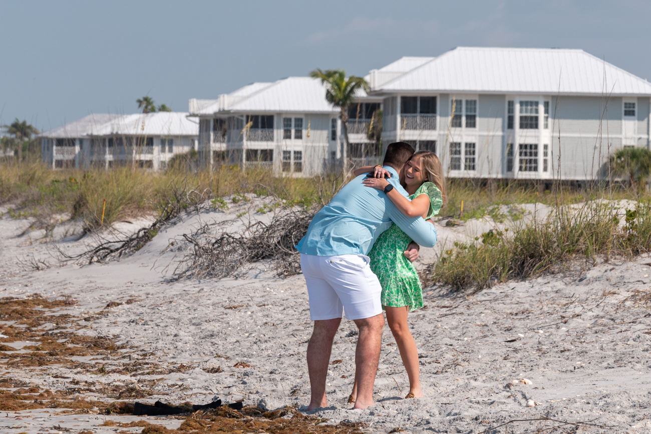 palm island surprise proposal with girl hugging her boyfriend after he proposes