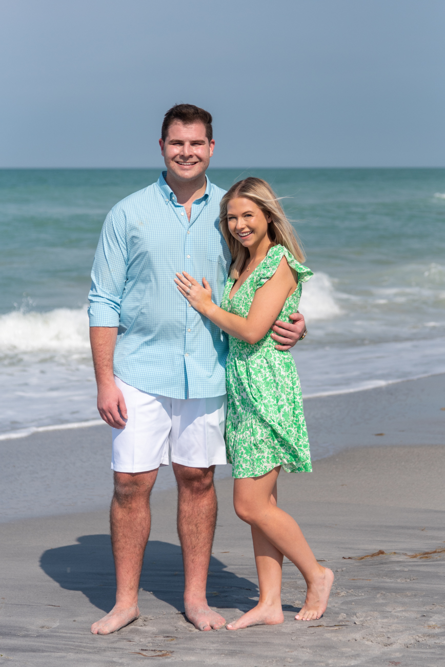 surprise engagement on Palm Island Florida with girl in green dress showing off her new engagement ring