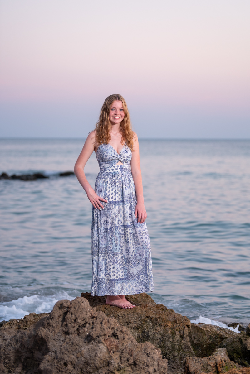 senior girl at Caspersen beach with Gulf behind her and the sky turning purple