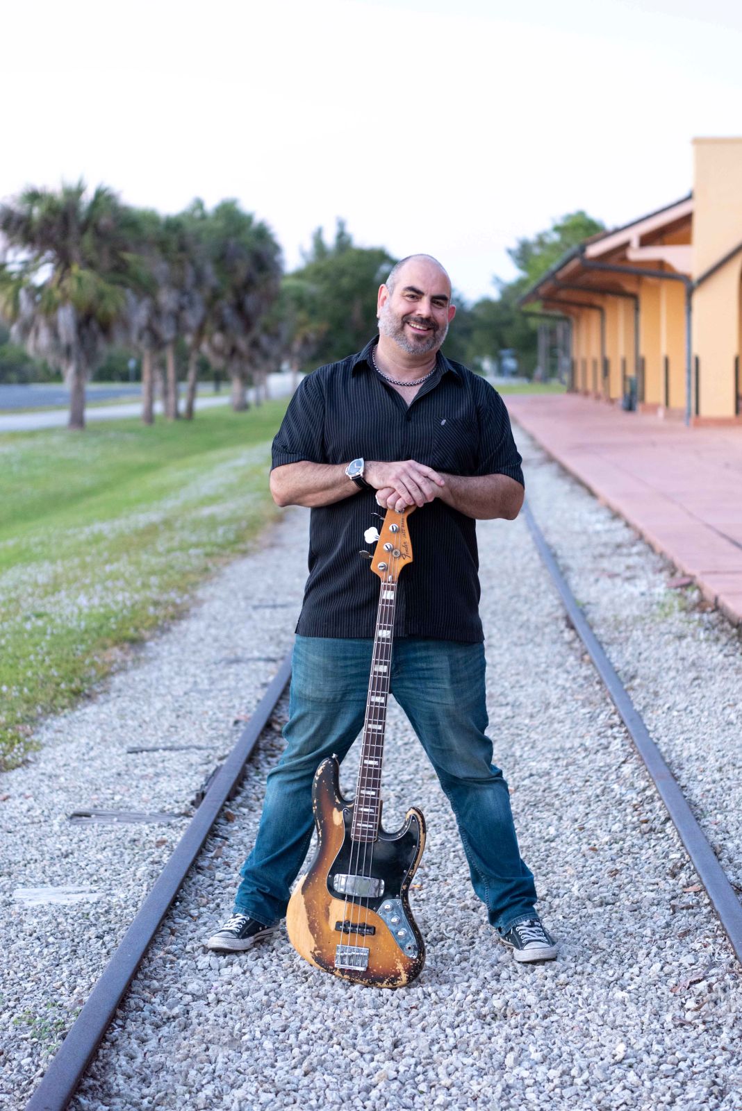 Chris showing off his guitar on the train tracks