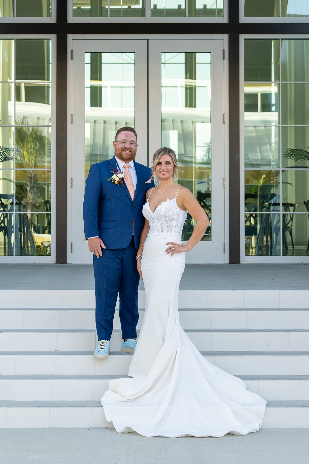 Bride and groom stand on steps of Solis Hall in Wellen Park