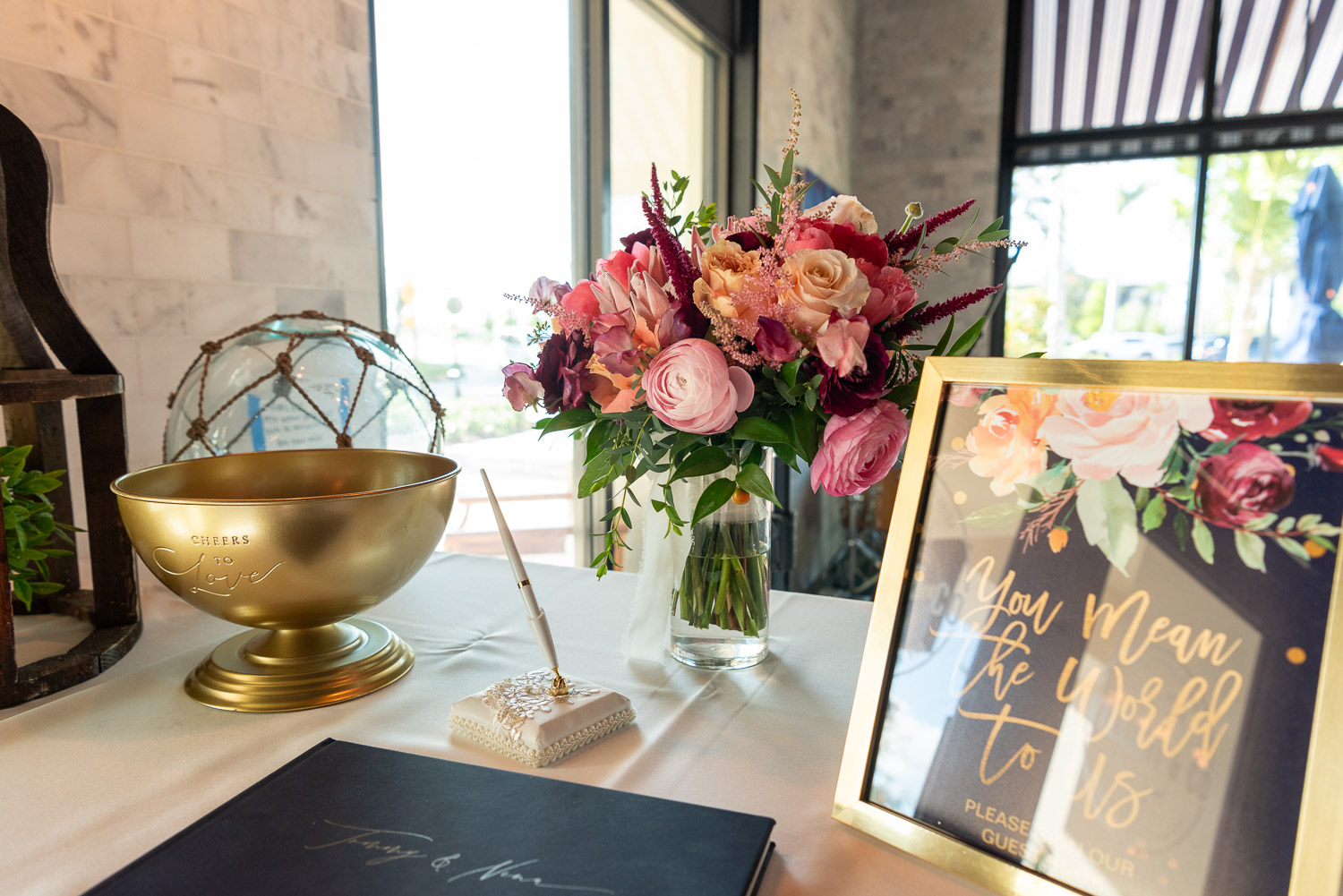 Flowers and sign in book at wedding reception