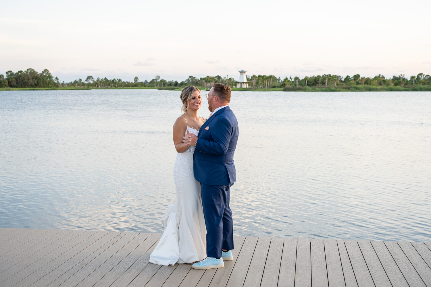 bride and groom share a quiet dance on the boardwalk at Wellen Park with the lighthouse in the distance