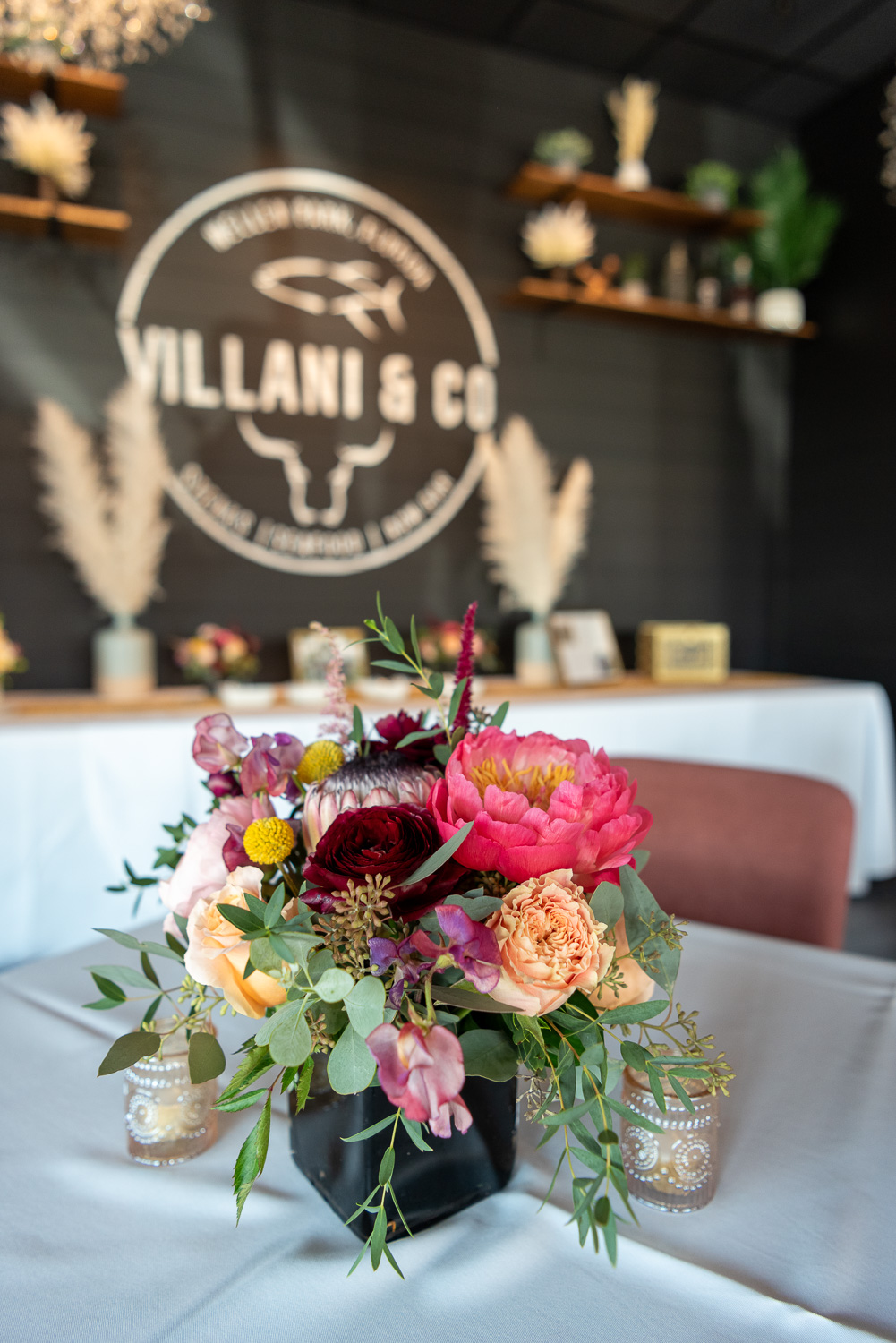 gorgeous flower arrangement on table at Villani & Co for wedding reception