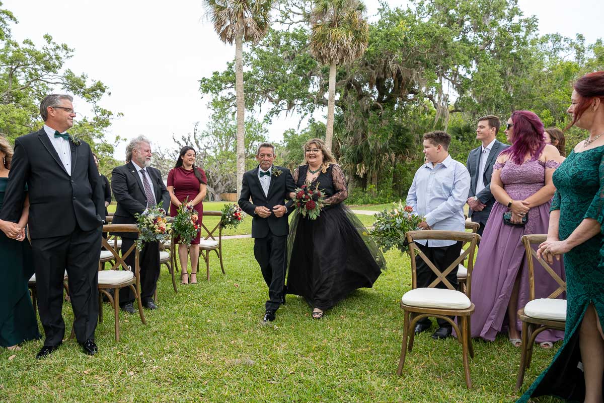 the bride walks down the aisle with her father