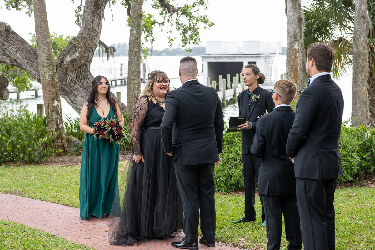 the bride looks excitedly at her husband during the ceremony at Bay Preserve at Osprey