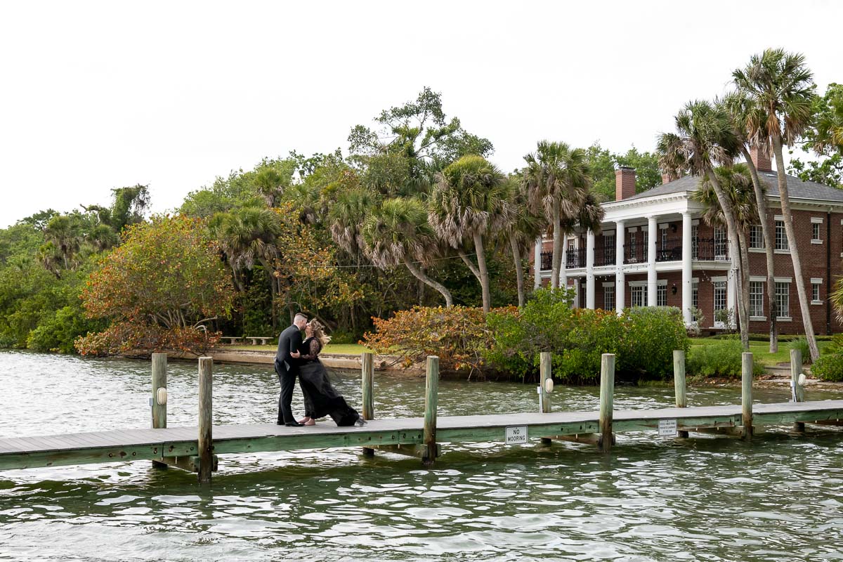 the bride and groom stand on the dock over the water at Bay Preserve at Osprey
