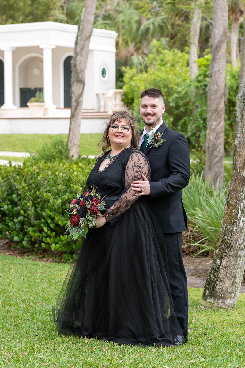 the groom wraps his arms around his bride