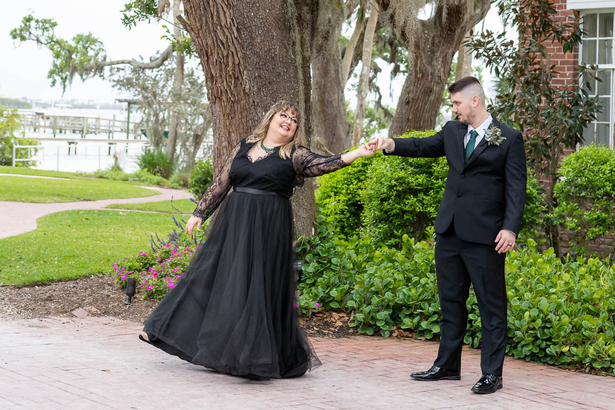 the bride and groom share a first dance in the parking lot before heading off to their reception