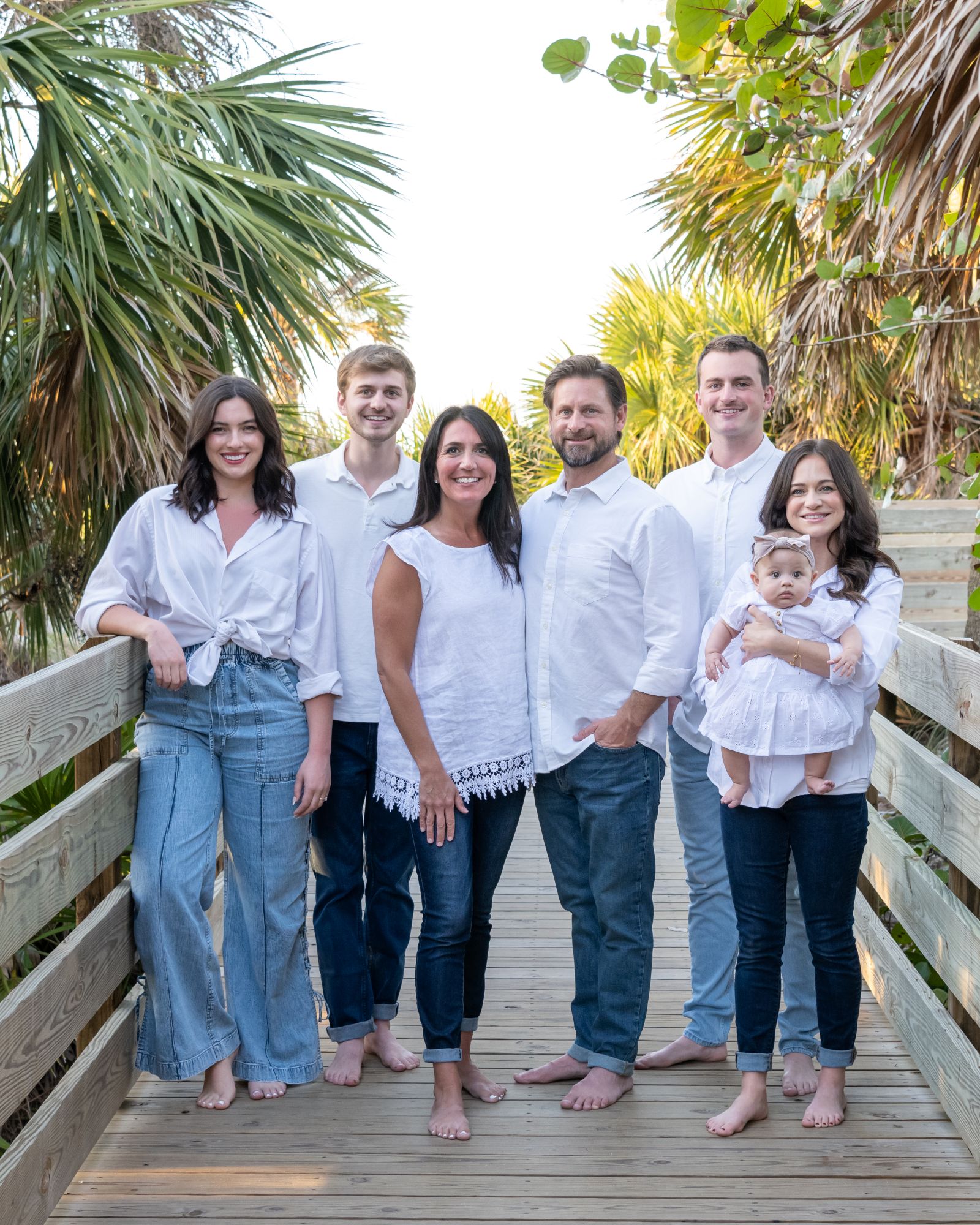 three generations of family together on a boardwalk