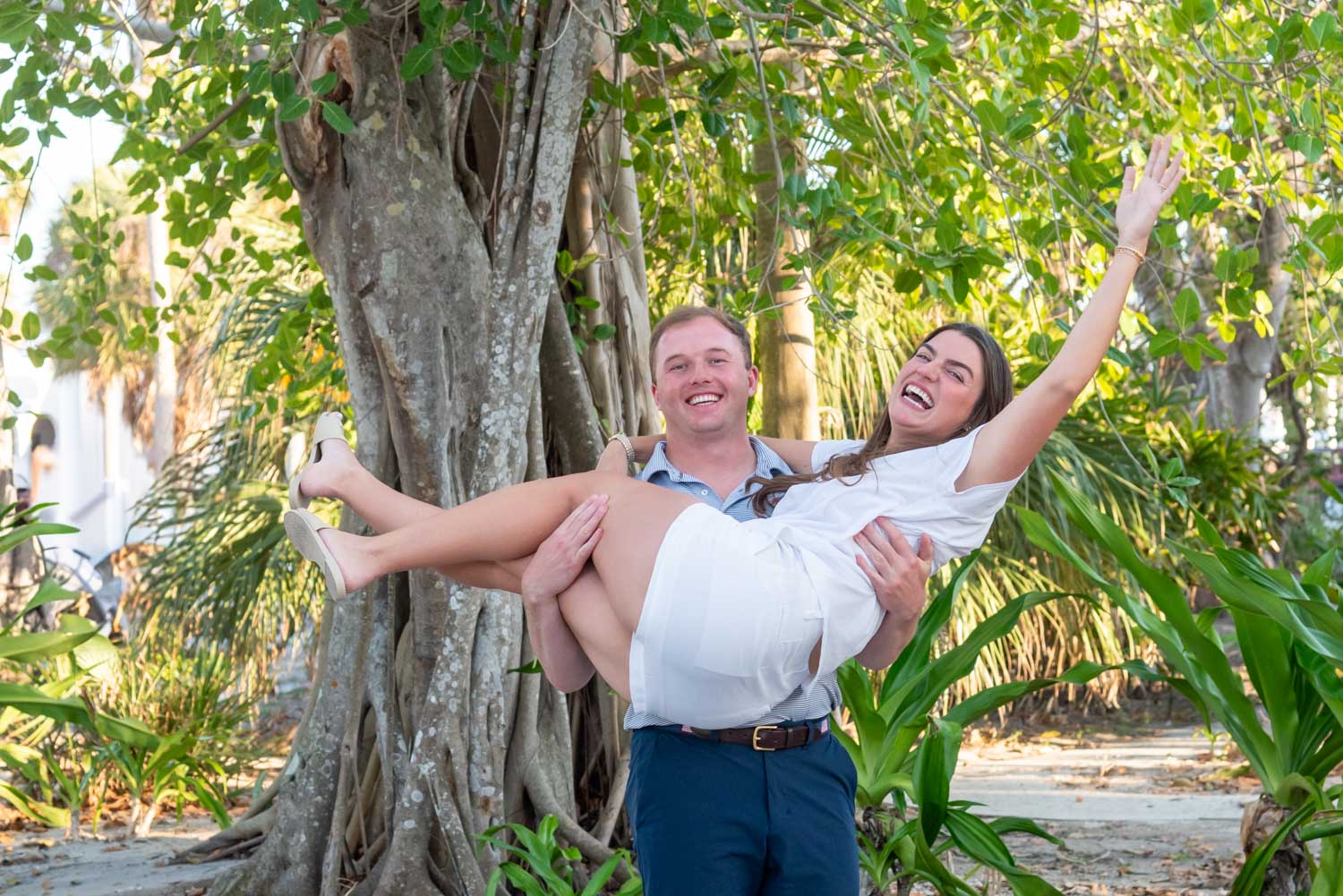 guy lifts his fiance in the air in excitement after he proposes to her