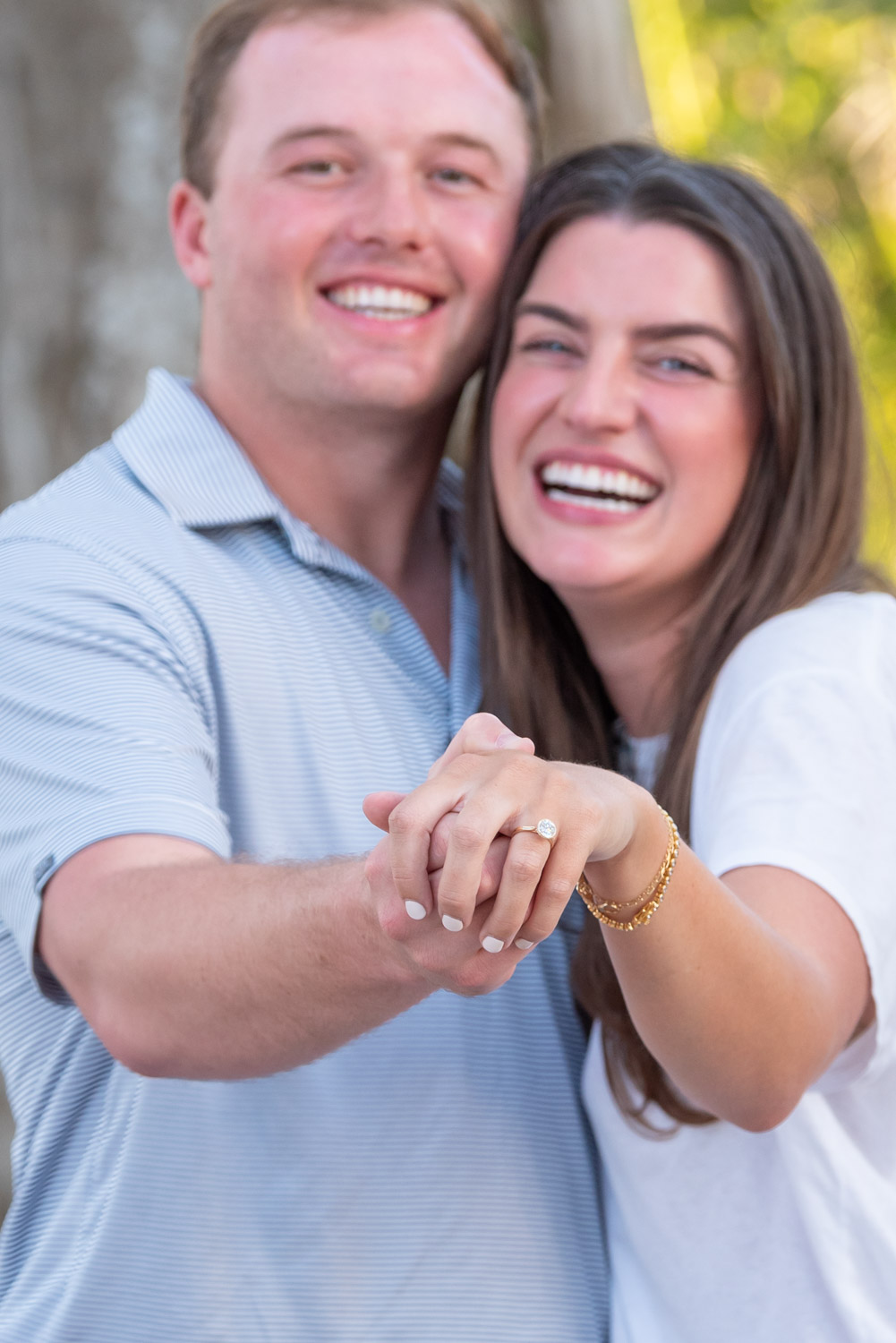 couple celebrating after surprise proposal on Banyan Street