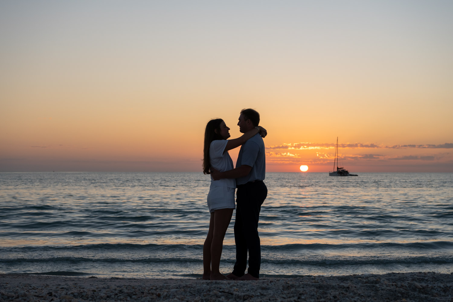 silhouette of couple on the beach at sunset