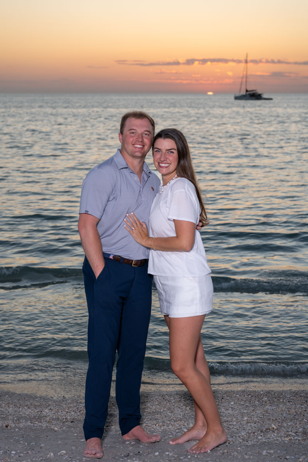 couple smiling as they celebrate their engagement on Boca Grande at the beach