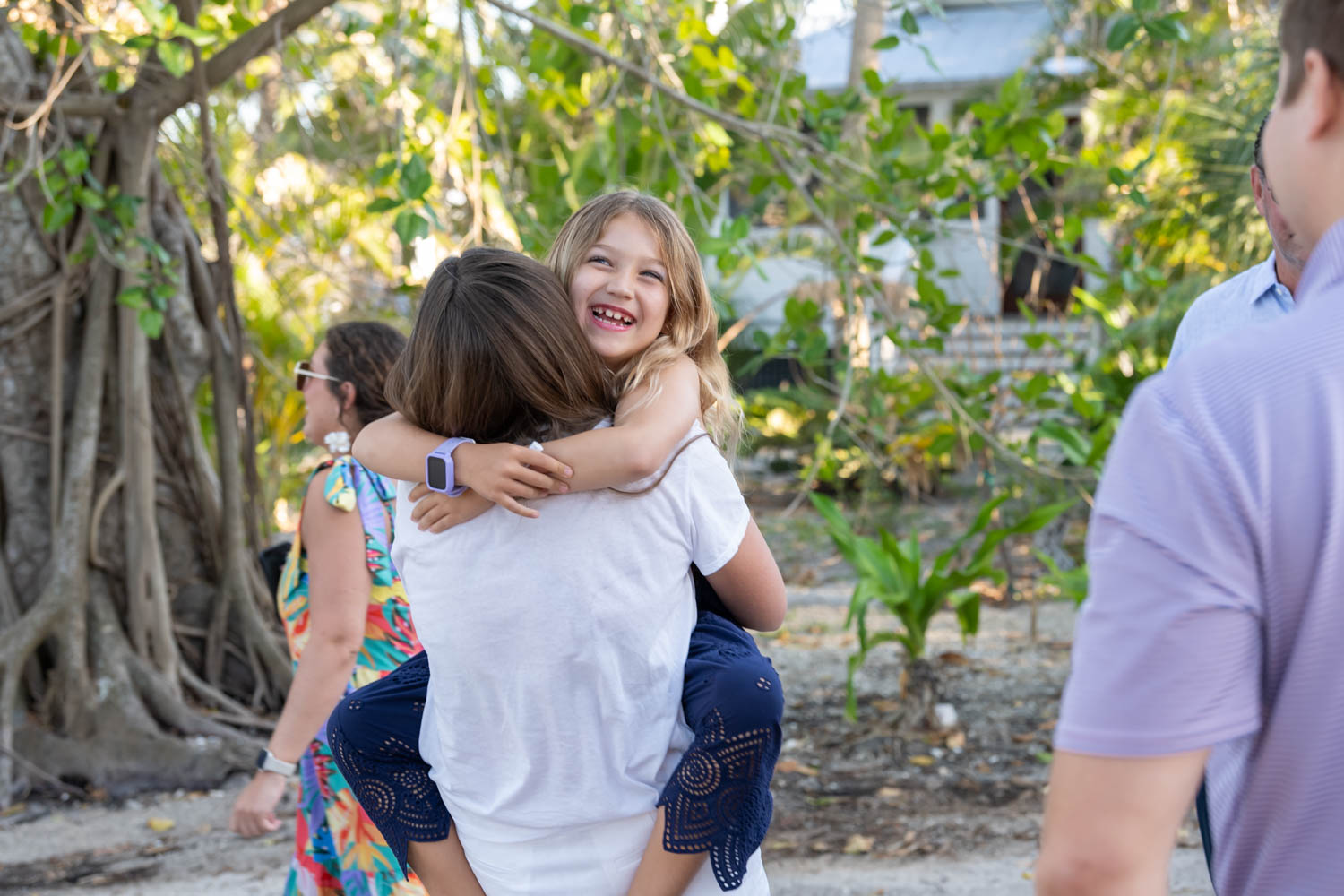 young girl hugs her sister in celebration
