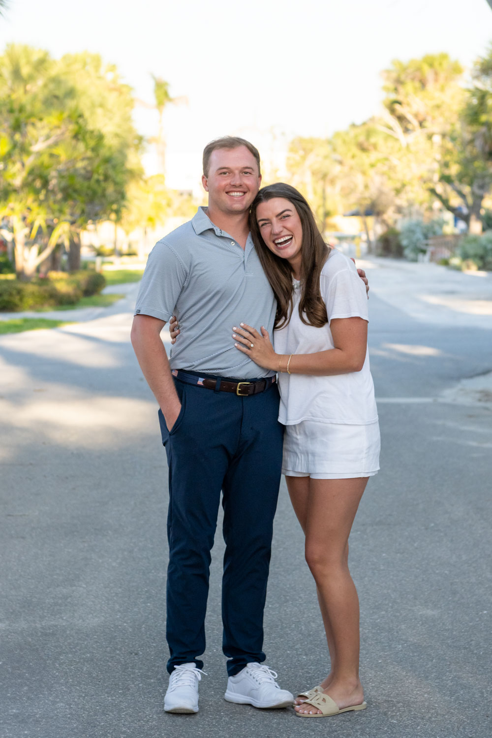 newly engaged couple stand together on Banyan Street in Boca Grande after proposal