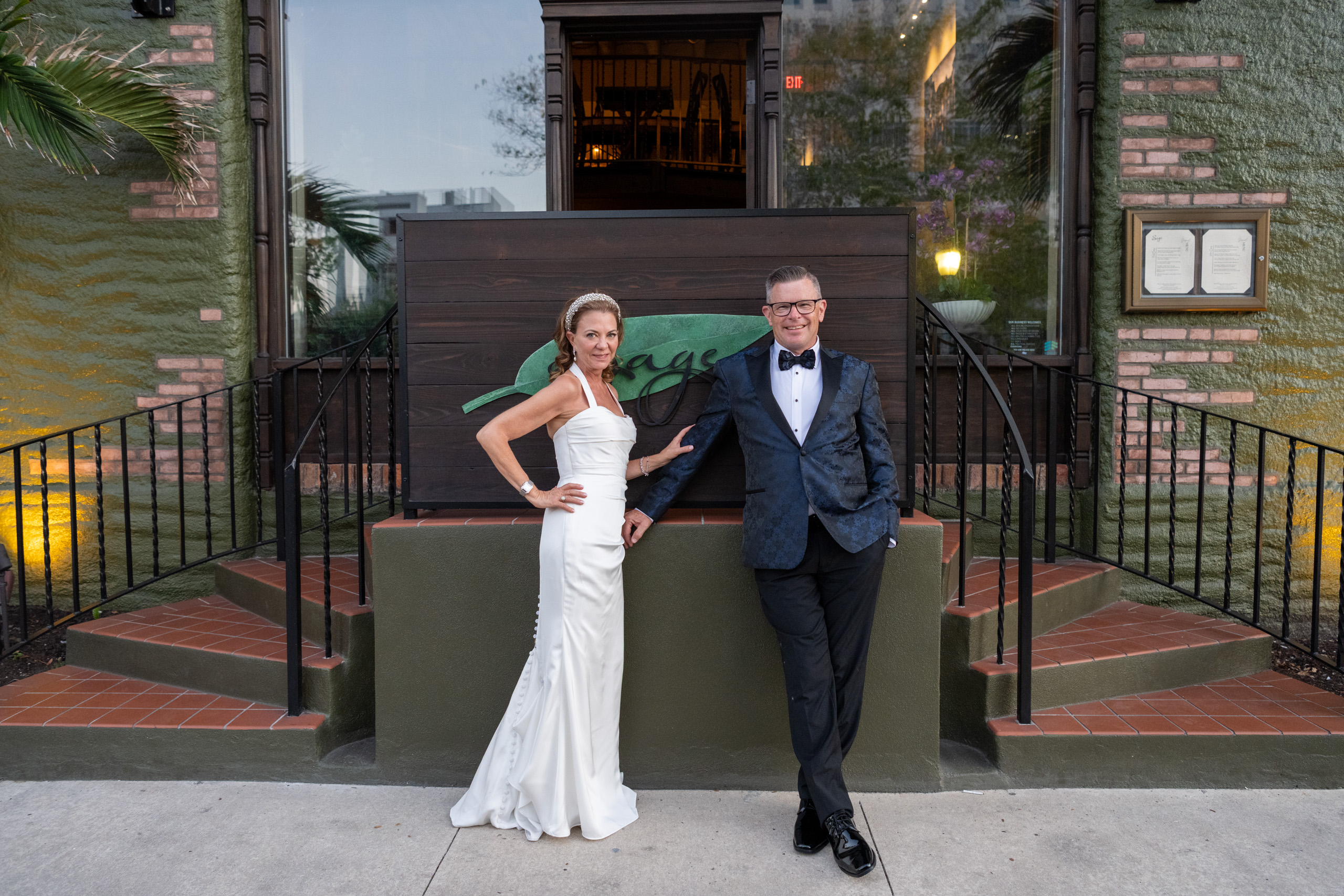 bride and groom stand outside Sage SRQ after wedding