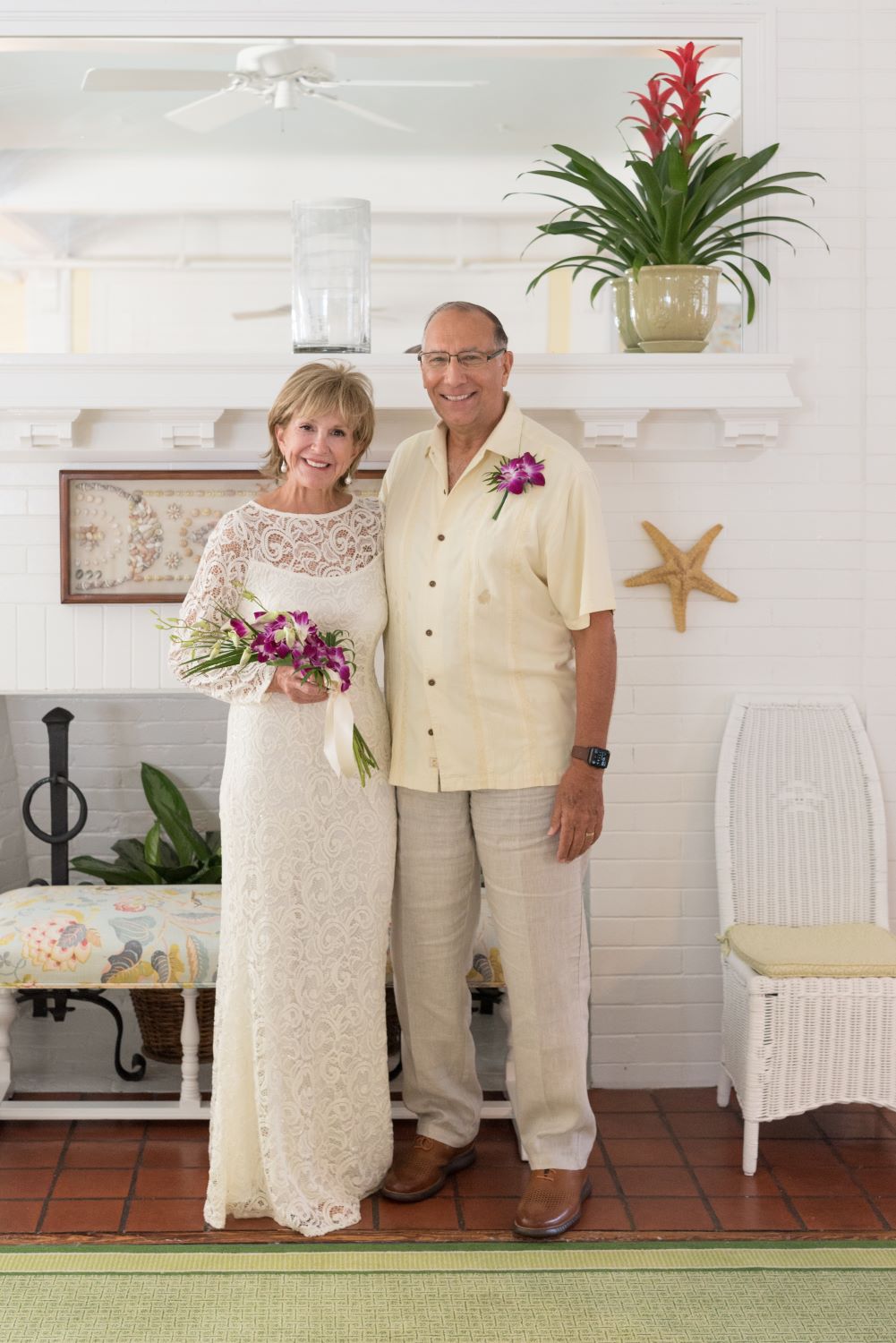 bride and groom in front of fireplace