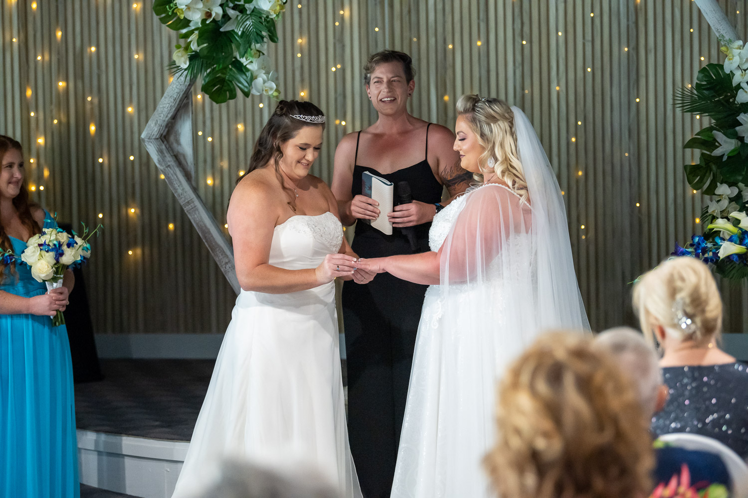 bride putting wedding ring on her bride