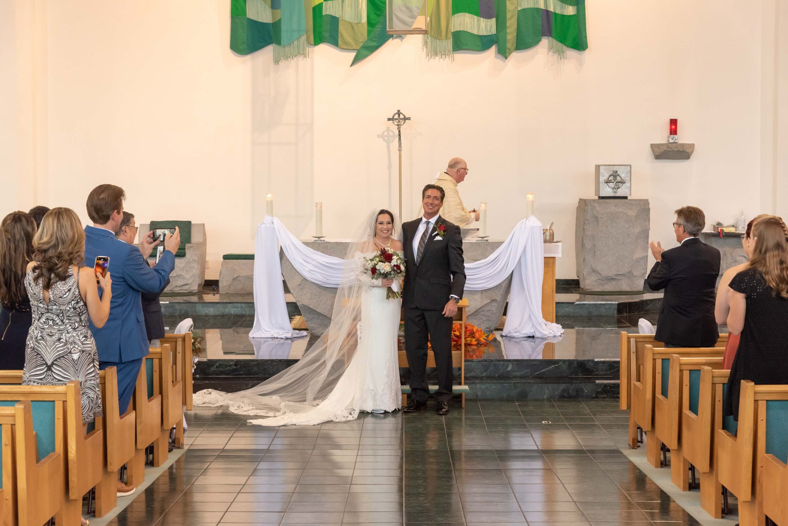 bride and groom turn to face congregation after their church weding