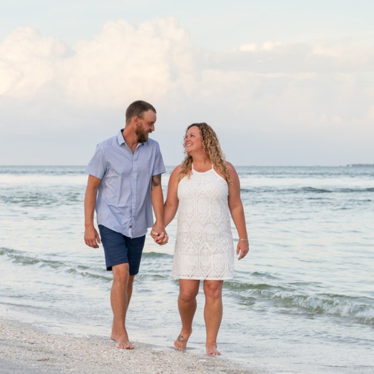 couple walking along the beach holding hands