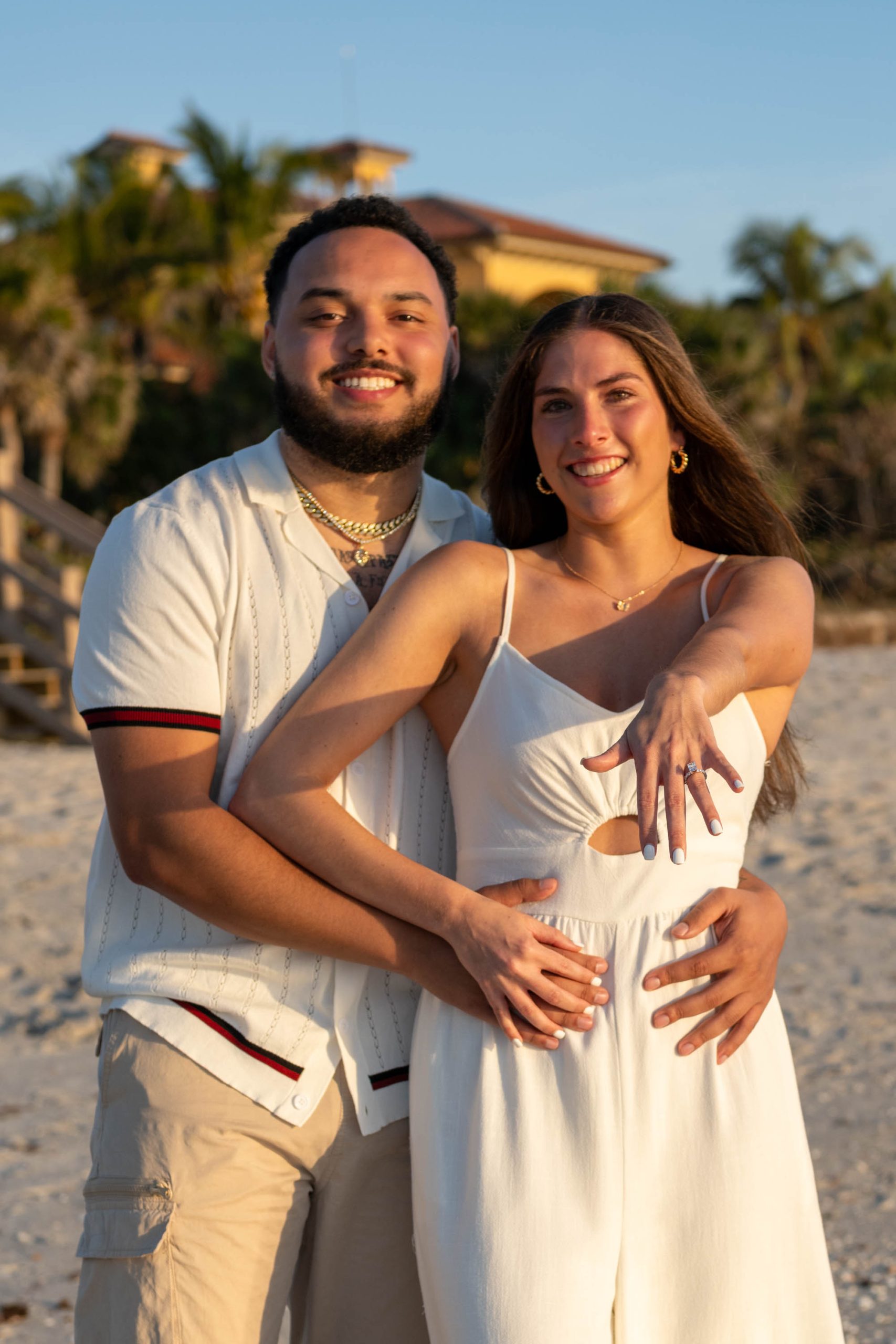 newly engaged couple show off her ring