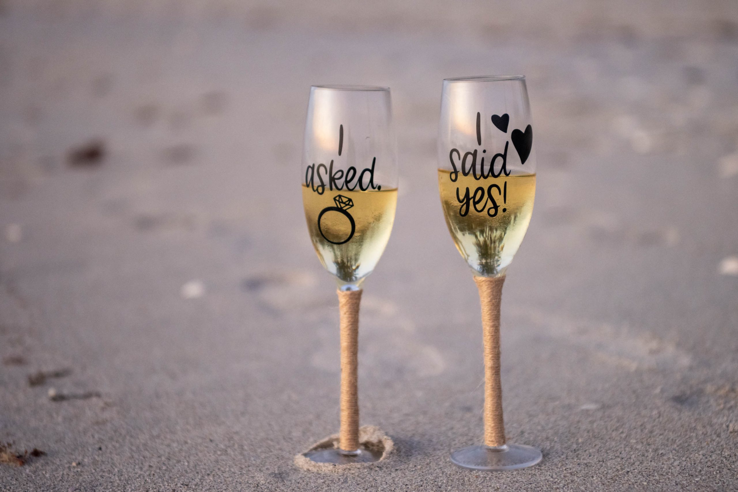 two champagne glasses, one says, "I asked" and the other says "I said yes!"