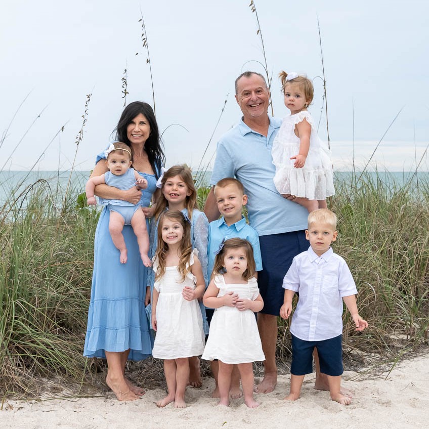 family with kids dressed in blue on the beach