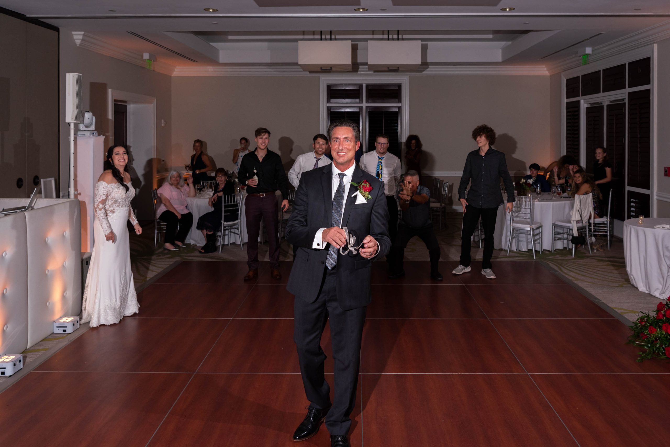 groom gets ready for garter throw