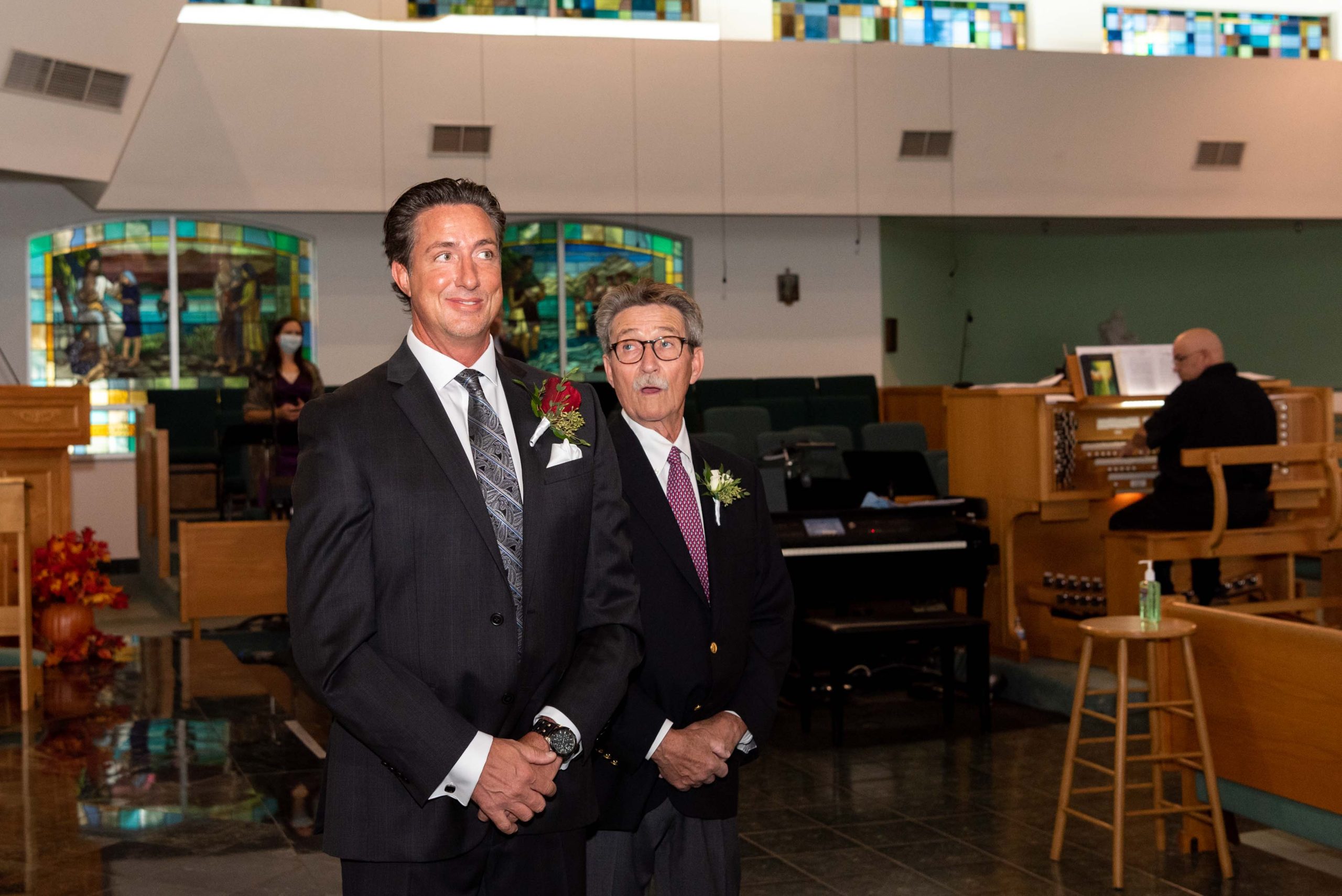 groom watching his bride walk down the aisle