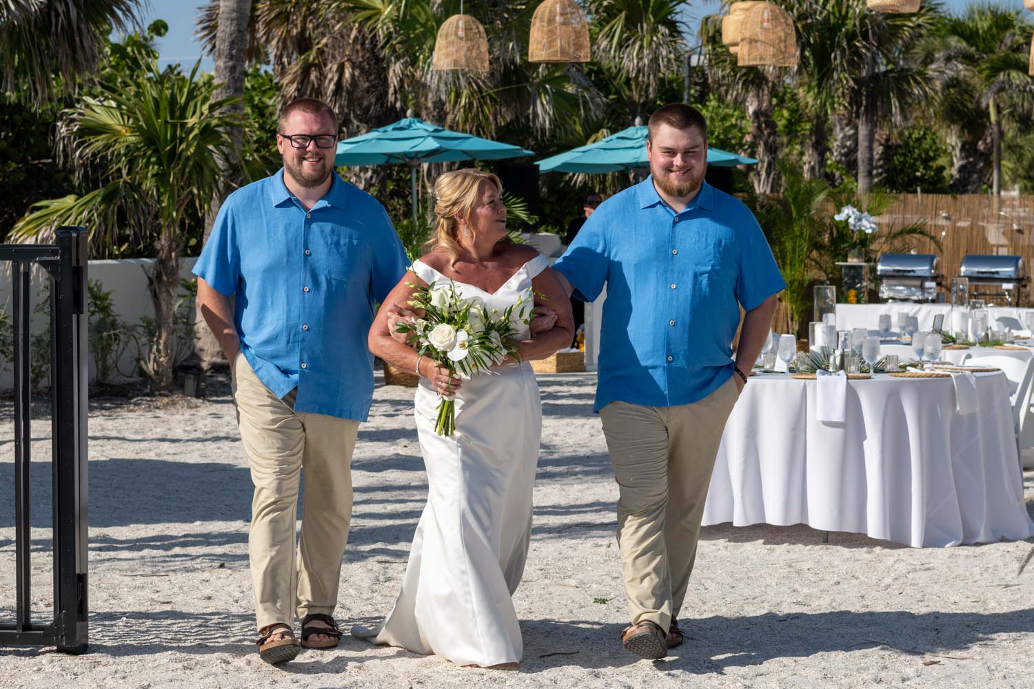 bride walking down the aisle with her sons